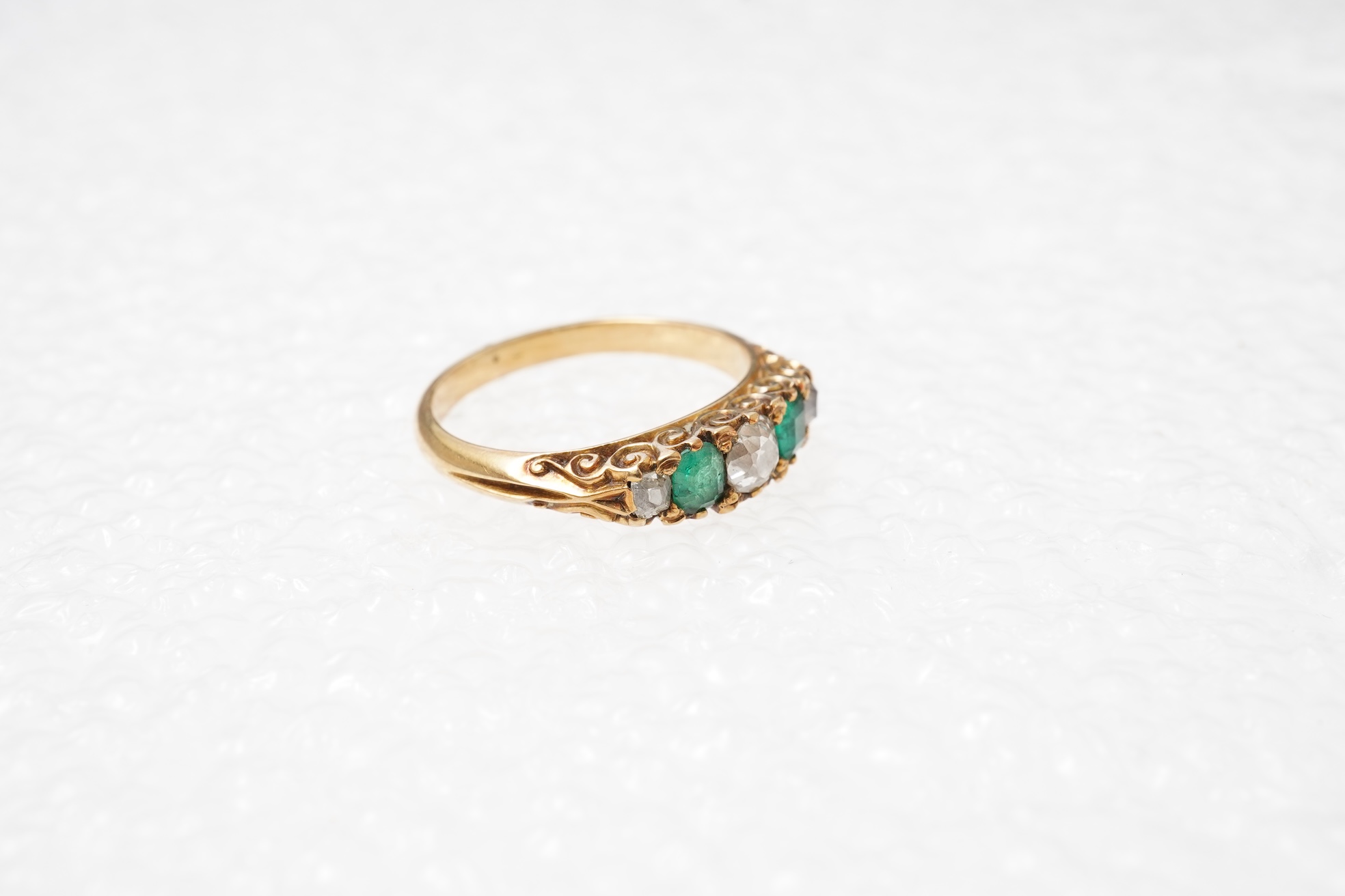 An emerald and diamond five-stone ring, circa 1900